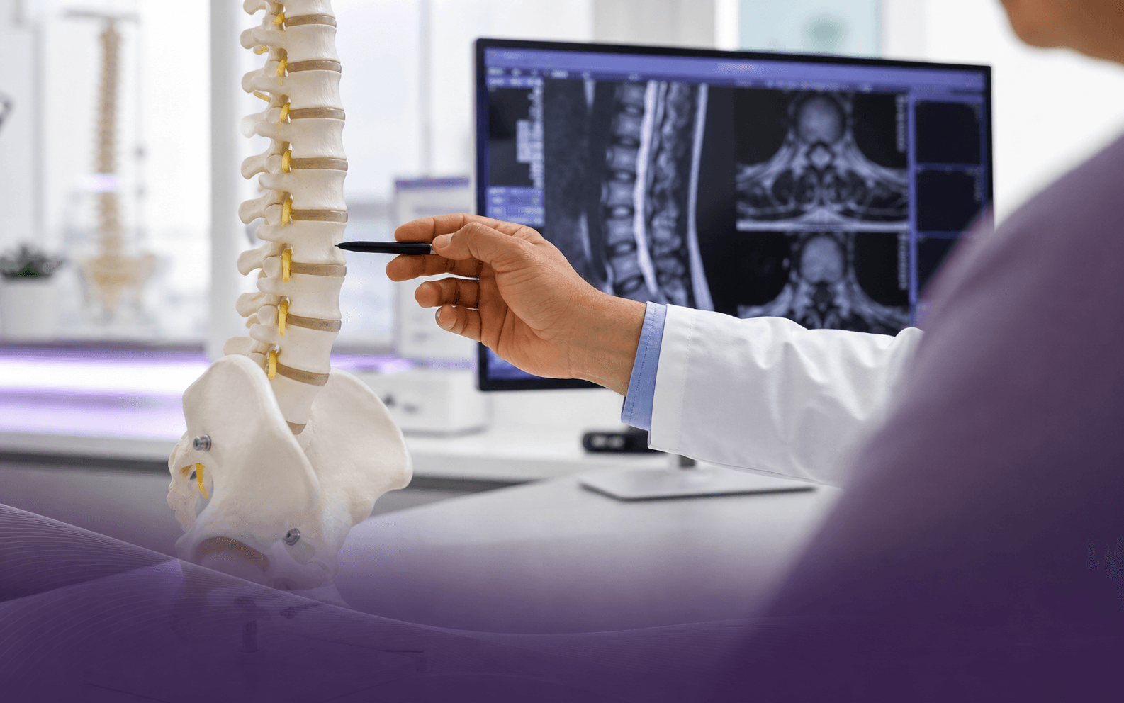Illustrative spine care consultation with spinal model and imaging